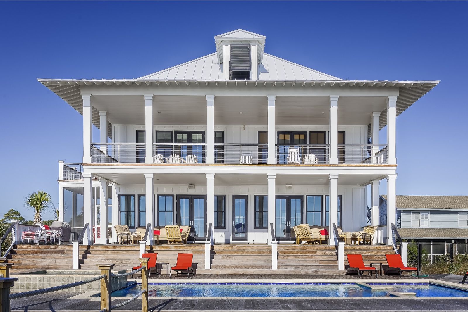 Luxury coastal Florida home with a resort-style pool and elevated outdoor living space